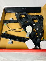 Entire window regulator assembly in box showing motor, rails, clips