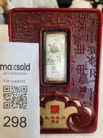 Bar in red presentation case with lot number card visible