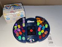 Open blue circular case showing stamps, ink pad and box