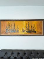 Full view of framed nautical painting over sofa