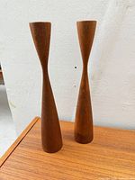 Pair of teak candlestick holders front view