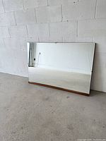 Front view of rectangular mirror leaning against wall