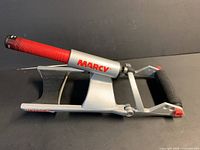 Side view of Marcy Wedge forearm developer showing red handle, arm cradle and roller pad