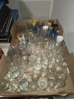 Top view of box filled with numerous shot glasses