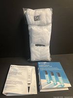 Entire set: sealed headband and wristbands pack, two SkinCeuticals sample brochures