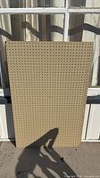 Front view of one pegboard panel showing full perforated surface