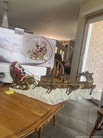Full view of Santa sleigh and reindeer with box behind on table