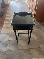 Full view of black telephone table front angle