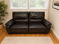 front view of black leather loveseat