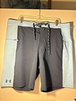 Front view of Under Armour board shorts showing color scheme and logo