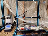 Full view of 3D printer, control box, accessories on bed
