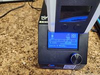 Control box with LCD screen and rotary knob displaying menu
