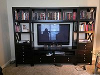 Front view of full entertainment center showing shelving towers, bridge and console