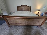 Front view showing footboard, leather panel and wood frame