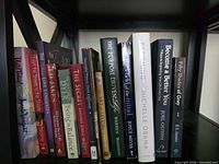 Shelf showing 15 assorted hardcover and paperback titles including Becoming, Purpose Driven Life, Fifty Shades of Grey