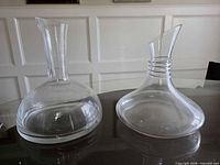 Both glass decanters side by side on table