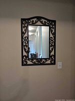 Full view of wall mirror showing frame design and mounted position