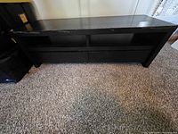 Front view of console showing open shelf and drawers