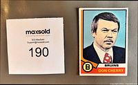 Front of Don Cherry rookie card beside lot number card