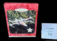 Front of original Hallmark Keepsake ornament box showing X-wing image and text