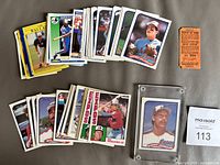 All cards spread in two stacks, Randy Johnson card in holder and rain-check ticket shown