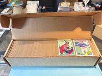 Full box filled with stacked Topps baseball cards, two cards visible on top