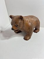 Front left view of brown resin bear figurine