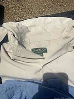 Collar and label of beige David Taylor shirt showing brand and fabric texture