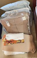 Assorted bed linens stacked together
