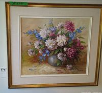 Full view of framed floral oil painting with dimensions tag visible