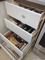 Drawer with multiple trays of flatware and utensils