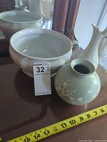 Footed bowl, celadon vase and bud vase with tape for scale