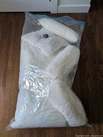 Vacuum-packed bag containing assorted white pillow inserts