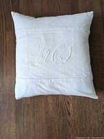 Front view showing embroidered "MO" monogram and overall fabric condition