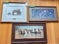 Three framed western prints on floor showing subjects and frames