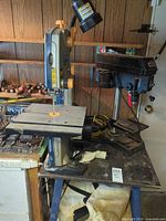 Band saw left, drill press right on workbench top