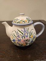 Full view of teapot with lid showing floral pattern and shape