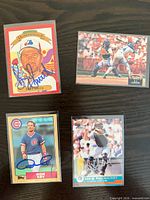 Group shot of four autographed baseball cards in sleeves