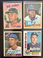 Front view showing all four autographed Topps baseball cards in sleeves