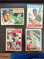 Group shot of all four autographed Topps cards in protective sleeves