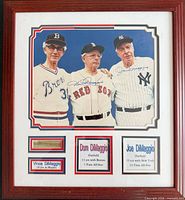 Full view of framed photo showing signatures, plaques and facsimile cut