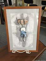 Full view of framed lithograph in wood frame with mat