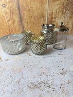 All five glass and metal pieces grouped together