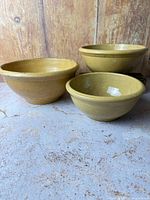All three yellowware stoneware bowls grouped together