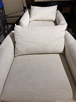 Front view showing seat and back cushions on both chairs