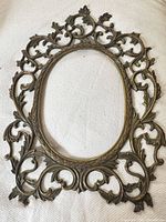 Front view of ornate brass frame