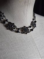 Full view of necklace on mannequin neck showing overall design and length