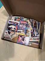 Open box filled with assorted baseball cards