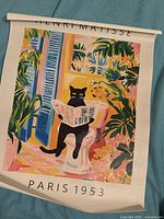Full view of rolled canvas print with cat image and Paris 1953 text