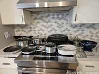 Overview of all cookware items arranged on stovetop